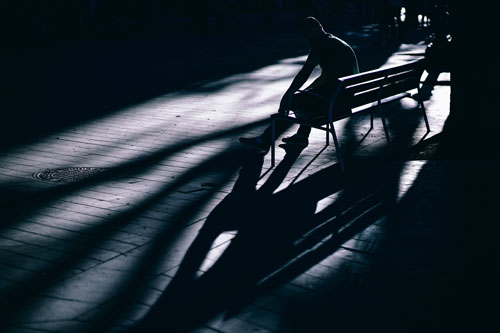 Silhouette of a teenage boy in a dark room